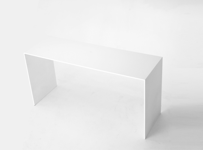 A right angle perspective of the minimalist white U shape bench with a rectangular top and two straight legs same thickness.