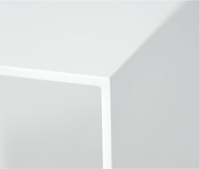 A detail of a corner on the U shape white bench. Top forms into same thickness leg.