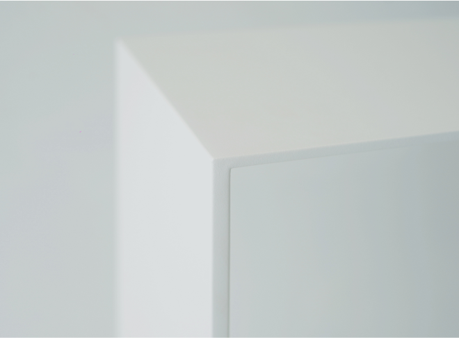 A detail of a corner on the U shape white console. Top forms into slightly thicker leg.