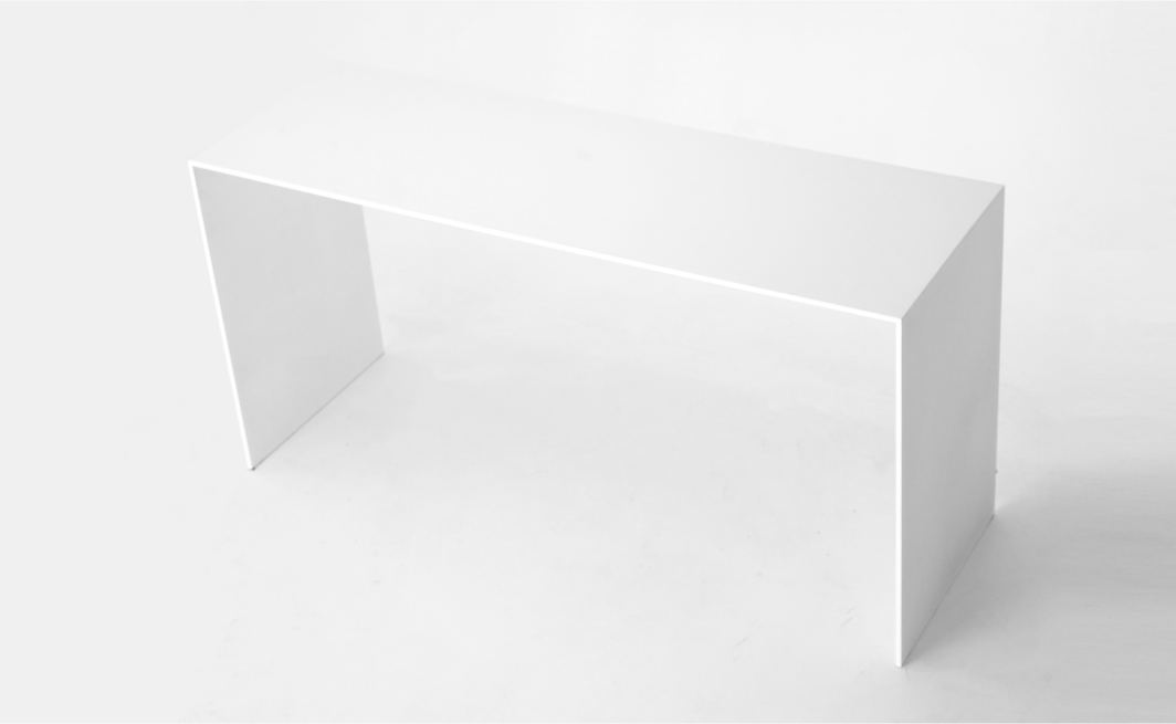 U shaped bench made out of solid aluminum plates and coated in white. 