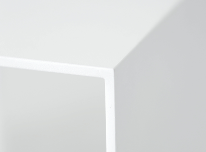A detail of a corner on the white side table.